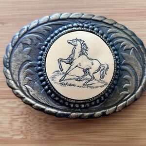 Vintage metal belt buckle with scrimshaw horse